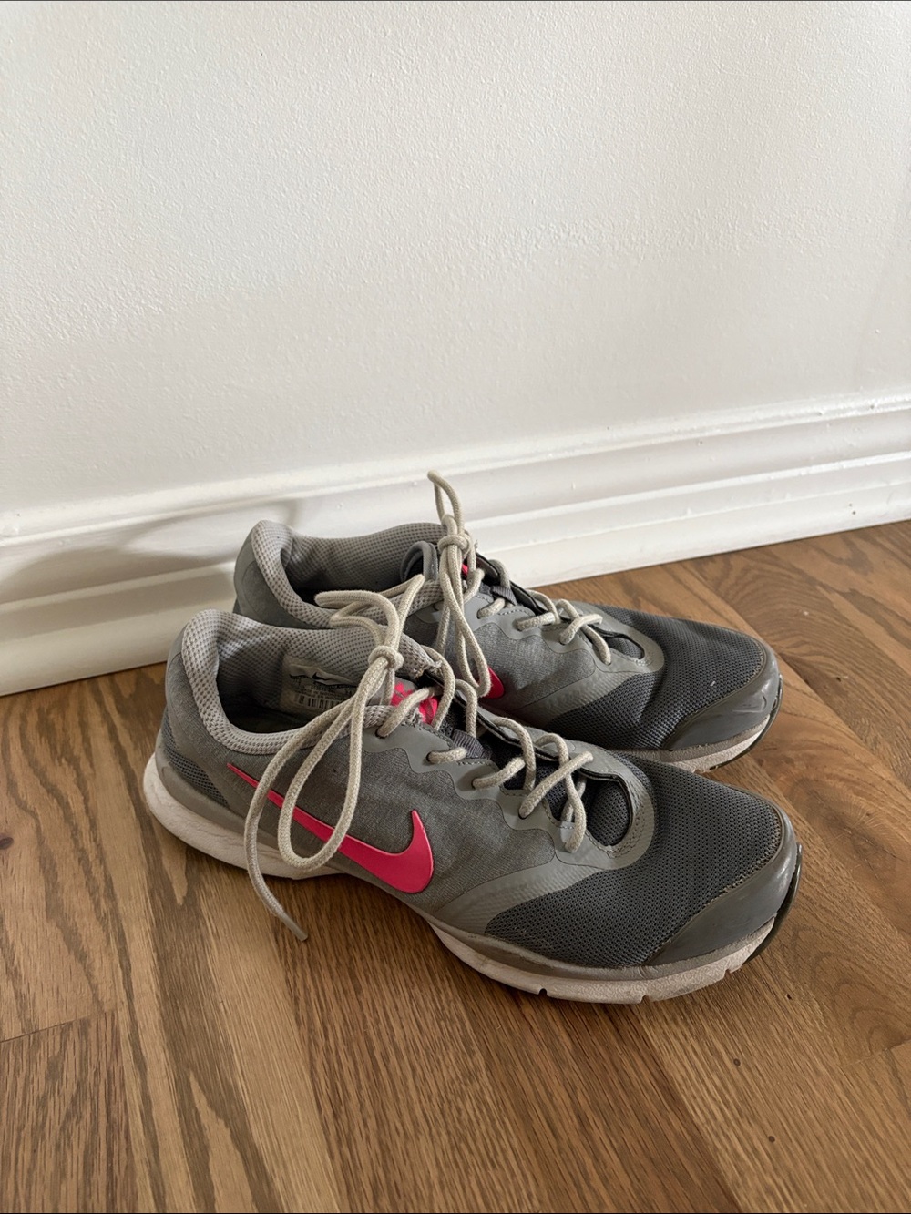 Nike Women's Gray Athletic Trainers with Pink Swoosh